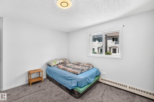 Neutral white walls featuring a single window and textured carpeting - #208 9619 174 St Nw, Edmonton, AB 