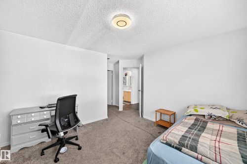 Spacious room featuring neutral carpet flooring and white painted walls - #208 9619 174 St Nw, Edmonton, AB 