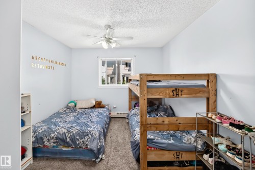 Carpeted room with a ceiling fan, a window, and light blue walls - #208 9619 174 St Nw, Edmonton, AB 