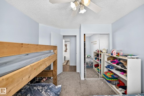 Carpeted interior space featuring a ceiling fan with integrated lighting - #208 9619 174 St Nw, Edmonton, AB 