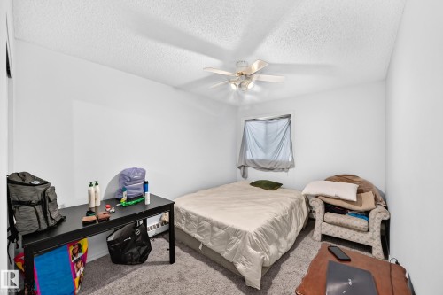 Room featuring light grey carpet, a ceiling fan with integrated lighting, and a single window - #208 9619 174 St Nw, Edmonton, AB 