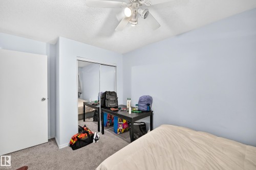 Bedroom featuring light blue walls and gray carpeting - #208 9619 174 St Nw, Edmonton, AB 