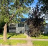 Single-story residence featuring light-colored siding and a dark shingle roof - 11938 70 Nw, Edmonton, AB 
