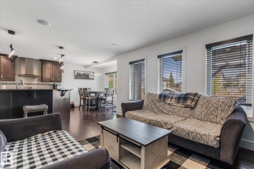 Open-concept living space featuring wood-finish flooring, recessed lighting, a kitchen island, and a dining area - 6 Sedona Place, Fort Saskatchewan, AB - Indoor Photo Showing Living Room