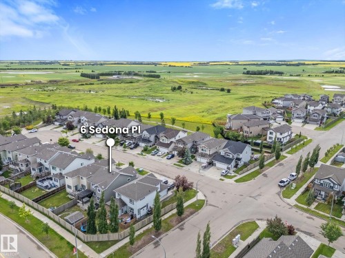 Residential street featuring a collection of properties with individual yards, mature landscaping, and paved roads - 6 Sedona Place, Fort Saskatchewan, AB - Outdoor With View