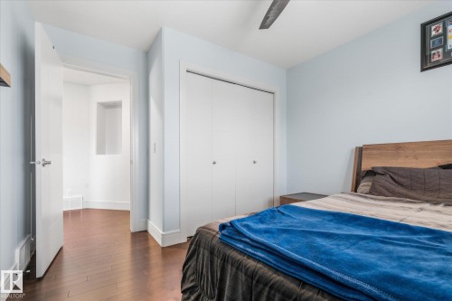 Bedroom featuring wood-finish flooring, light blue walls, and white trim - 6 Sedona Place, Fort Saskatchewan, AB - Indoor Photo Showing Bedroom