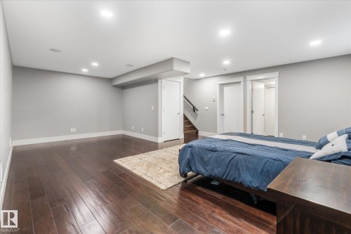 Spacious room featuring dark wood-finish flooring, recessed lighting, and light grey walls - 6 Sedona Place, Fort Saskatchewan, AB - Indoor