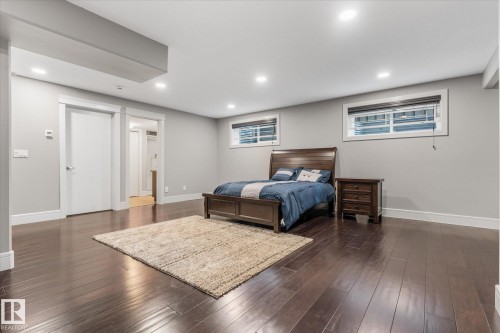 Spacious room featuring rich wood-finish flooring, recessed lighting, and light grey walls - 6 Sedona Place, Fort Saskatchewan, AB - Indoor Photo Showing Basement