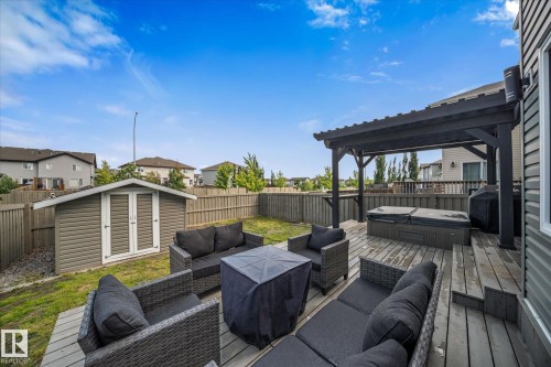 Spacious backyard featuring a multi-level wood deck, a dark wood pergola, and a privacy fence - 6 Sedona Place, Fort Saskatchewan, AB - Outdoor With Deck Patio Veranda