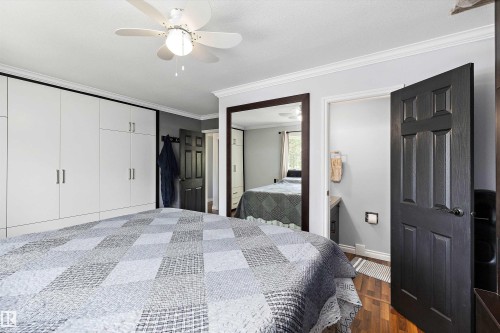 Bedroom featuring a white ceiling fan, wood-finish flooring, and crown molding - 53257 Rge Road 211, Rural Strathcona County, AB - Indoor Photo Showing Bedroom