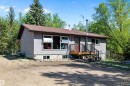 Ranch-style residence featuring a gray exterior, brown asphalt shingle roof, and multiple large windows - 53257 Rge Road 211, Rural Strathcona County, AB  - Outdoor 
