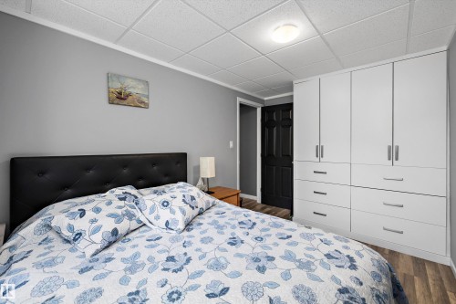 Bedroom featuring light gray walls, white crown molding, and wood-finish flooring - 53257 Rge Road 211, Rural Strathcona County, AB - Indoor Photo Showing Bedroom