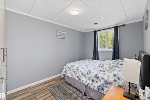 Room featuring grey painted walls, recessed lighting, white baseboards, wood-finish flooring, and a window with white trim - 53257 Rge Road 211, Rural Strathcona County, AB - Indoor Photo Showing Bedroom