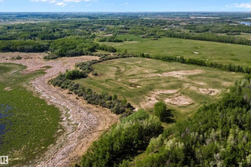 Expansive land parcel featuring diverse terrain, including areas of dense forest, open grassy fields, and natural wetlands - 53257 Rge Road 211, Rural Strathcona County, AB - Outdoor With View