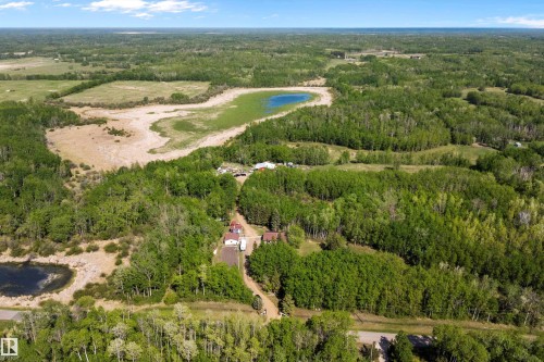 Expansive wooded property featuring multiple clearings, a natural pond, and two distinct structures - 53257 Rge Road 211, Rural Strathcona County, AB - Outdoor With View
