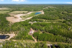 Expansive wooded property featuring multiple clearings, a natural pond, and two distinct structures - 