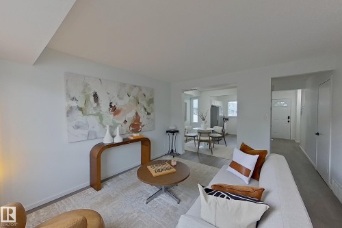 Bright living room with light-toned walls and plush carpeting - 209 Dickinsfield Court Nw, Edmonton, AB 