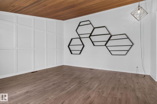 Interior room featuring wood-finish flooring and a wood panel ceiling - 1071 Millbourne Road Nw, Edmonton, AB 