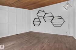 Interior room featuring wood-finish flooring and a wood panel ceiling - 