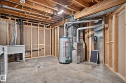 Unfinished basement with concrete flooring and exposed ceiling joists - 