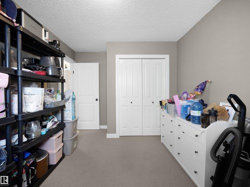 Interior space featuring light gray wall paint, textured ceiling, and gray carpeting - 4021 158 Avenue Nw, Edmonton, AB - Indoor