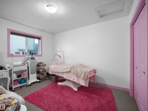 Carpeted room with a ceiling-mounted light fixture and a window with blinds - 4021 158 Avenue Nw, Edmonton, AB - Indoor Photo Showing Bedroom