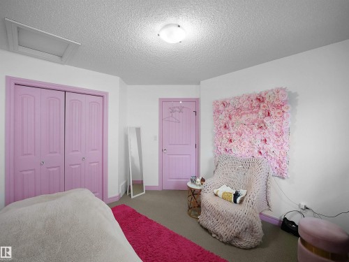 Carpeted room featuring white walls, a flush-mount ceiling light, and a ceiling access panel - 4021 158 Avenue Nw, Edmonton, AB - Indoor Photo Showing Bedroom