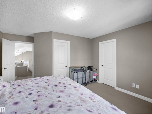 Bedroom with neutral-toned walls and carpet flooring - 4021 158 Avenue Nw, Edmonton, AB - Indoor Photo Showing Bedroom