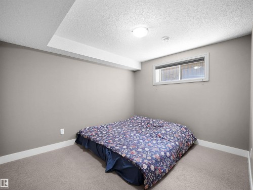 Carpeted room with neutral wall tones and a single horizontal window - 4021 158 Avenue Nw, Edmonton, AB - Indoor Photo Showing Bedroom