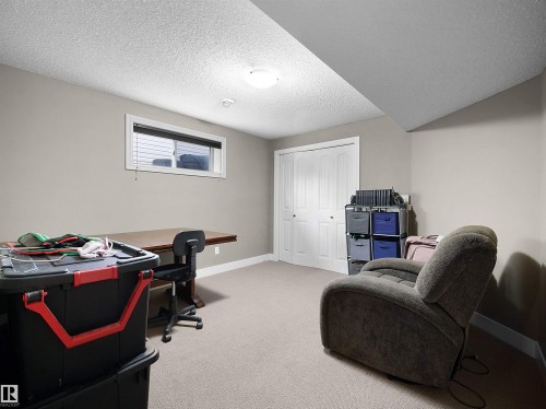Carpeted room featuring a white bi-fold closet, a single window with blinds, and recessed lighting - 4021 158 Avenue Nw, Edmonton, AB - Indoor Photo Showing Office