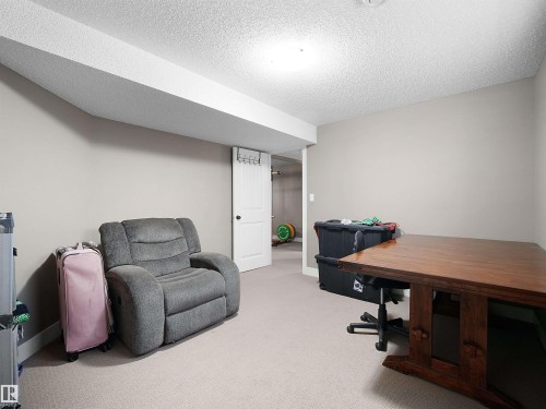 Carpeted room with neutral wall tones and a textured ceiling - 4021 158 Avenue Nw, Edmonton, AB - Indoor