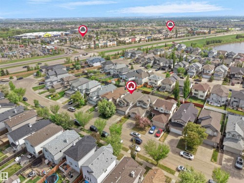 Residential neighborhood with varied architectural styles, a nearby commercial district, a large body of water, and thoroughfares - 4021 158 Avenue Nw, Edmonton, AB - Outdoor With View