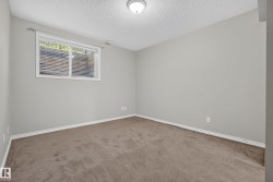 Light gray painted walls with white trim and a neutral carpeted floor create a versatile interior - 