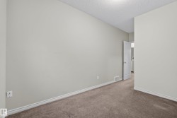 Room featuring neutral wall tones, textured ceiling, baseboard trim, and carpet flooring - 