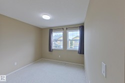 Room featuring neutral wall tones and light-colored carpeting - 