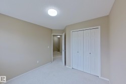 Neutral-toned room featuring a white ceiling and light beige walls - 
