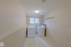 Dedicated laundry area featuring a window, built-in shelving, durable flooring, and light-toned walls - 