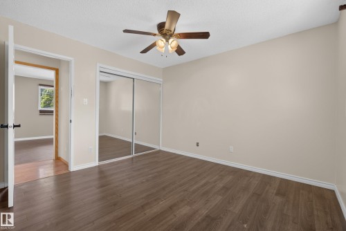 Spacious room with wood-finish flooring, light neutral wall paint, and white trim - 3 Bristow Crescent, Spruce Grove, AB - Indoor Photo Showing Other Room
