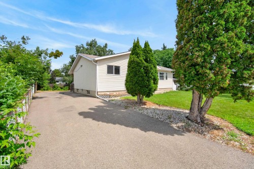 Exterior featuring light-colored siding, multiple windows, and a foundation - 3 Bristow Crescent, Spruce Grove, AB - Outdoor