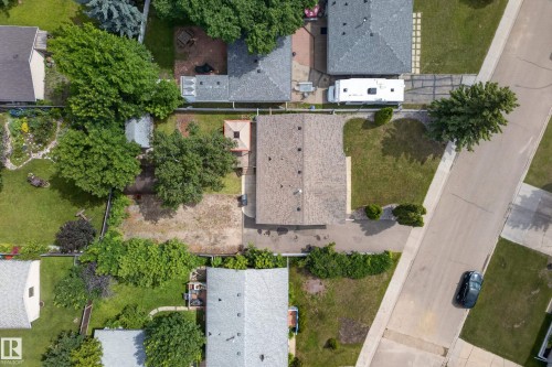 Residential property with a shingle roof and a spacious backyard featuring mature trees - 3 Bristow Crescent, Spruce Grove, AB - Outdoor With View