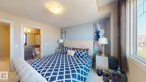 Bedroom with light-toned carpet flooring and a neutral color palette - 6824 Evans Wynd Nw, Edmonton, AB - Indoor Photo Showing Bedroom