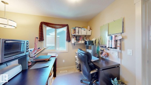 Neutral-toned walls complement the window with natural light and a decorative valance - 6824 Evans Wynd Nw, Edmonton, AB - Indoor Photo Showing Office