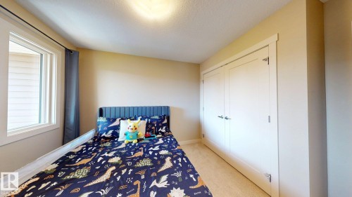Windowed room featuring light-colored walls and carpet flooring - 6824 Evans Wynd Nw, Edmonton, AB - Indoor Photo Showing Bedroom