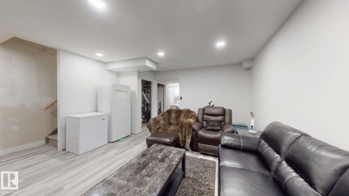 Spacious room with light-toned wood-finish flooring and recessed lighting - 6824 Evans Wynd Nw, Edmonton, AB - Indoor Photo Showing Other Room