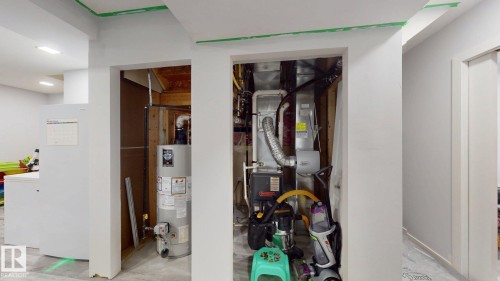 Dedicated utility closets featuring a water heater and furnace - 6824 Evans Wynd Nw, Edmonton, AB - Indoor Photo Showing Other Room
