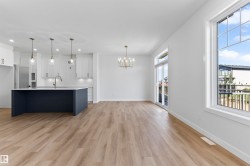 Expansive open-concept space featuring wood-finish flooring - 