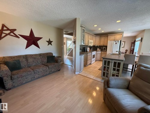 Open-concept living space featuring light wood-finish flooring - 5604 57 Avenue, Beaumont, AB 