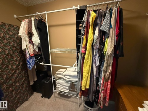 Customizable closet organization system with multiple hanging rods and wire shelving - 5604 57 Avenue, Beaumont, AB 
