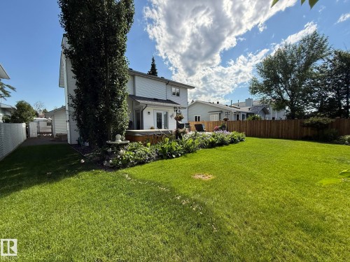 Expansive green lawn with a wood-fenced perimeter - 5604 57 Avenue, Beaumont, AB 
