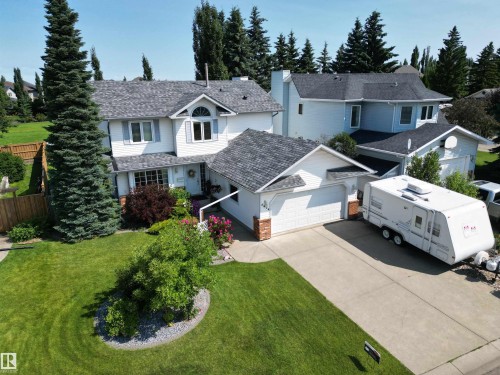 White two-story residence with gray shingle roofing - 5604 57 Avenue, Beaumont, AB 